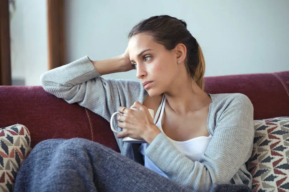 woman frozen on couch overwhelmed by responsibilities