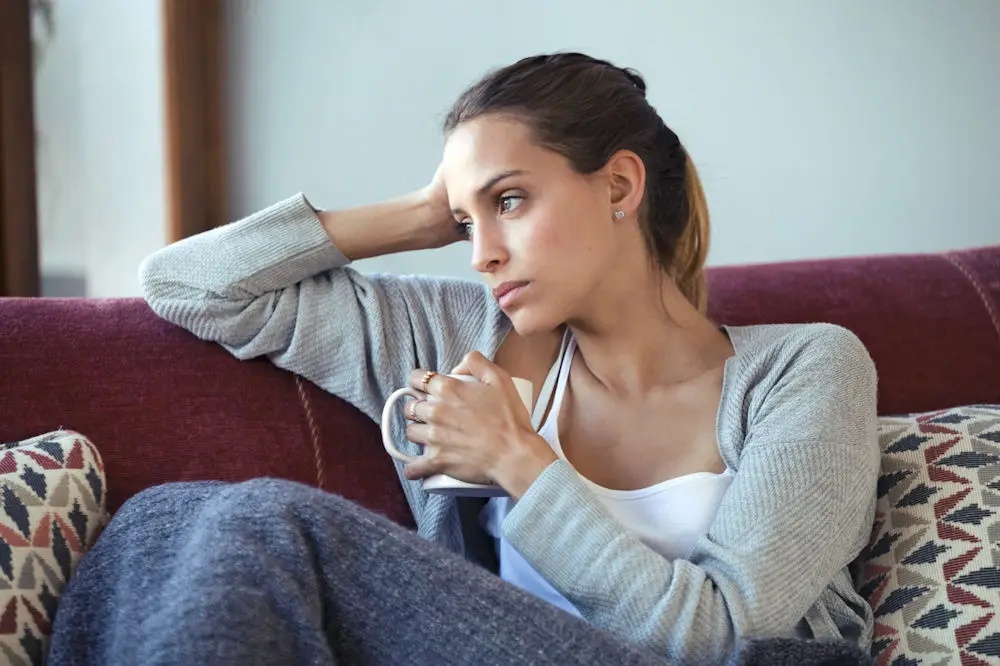 woman frozen on couch overwhelmed by responsibilities