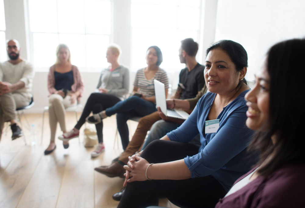 group therapy session for people recovering from burnout, stress, and mental health challenges