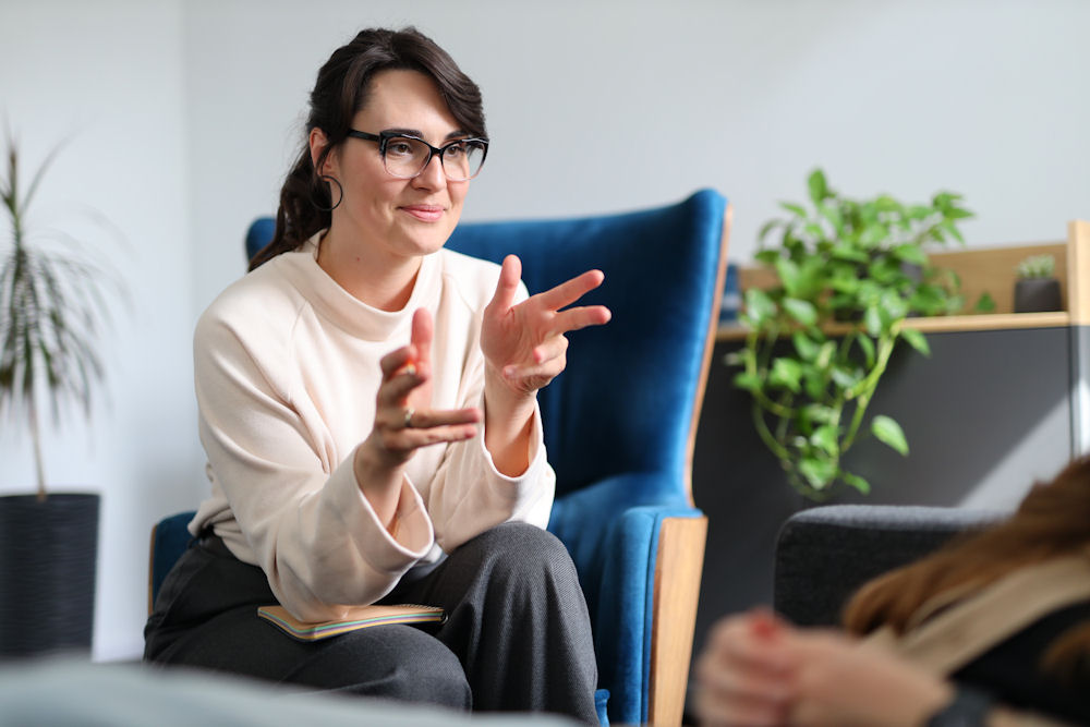 Trauma-informed therapist supporting an adult recovering from PTSD or CPTSD