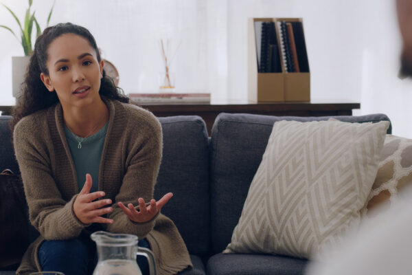 Person speaking with a therapist about anger management and addiction recovery during a counseling session.