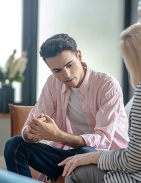 Young adult participating in individual therapy session with counselor