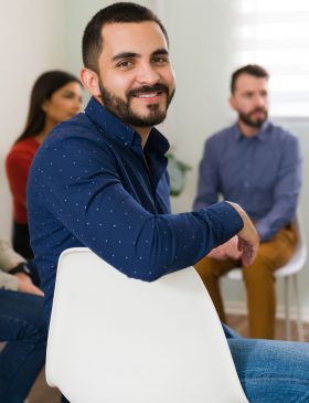 Group therapy session for college students in addiction recovery